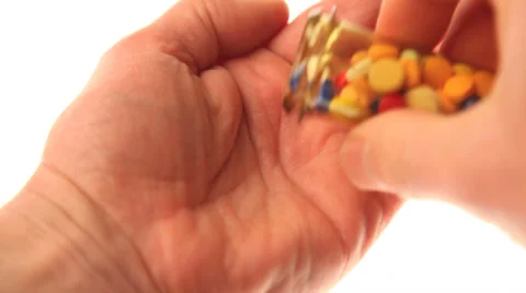 Placing pills in a hand Stock Footage 32243479