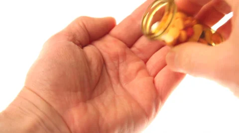 Placing pills in a hand Video stock 32243495