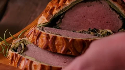 Placing plate of Beef Wellington on rustic wooden table Stock Footage 328094513