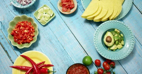 Placing a plate of pineapple chunks on blue wooden table Stock Footage 61535380