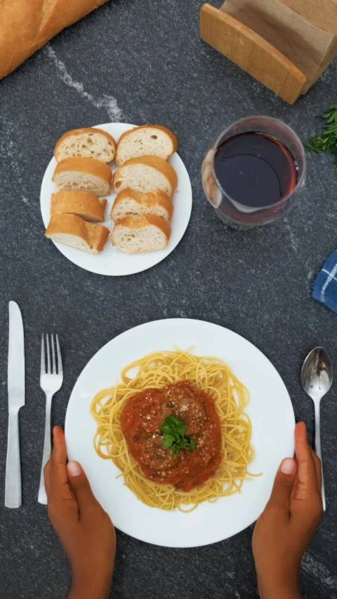 Placing a plate of spaghetti bolognese on a table Stock Footage 257870457