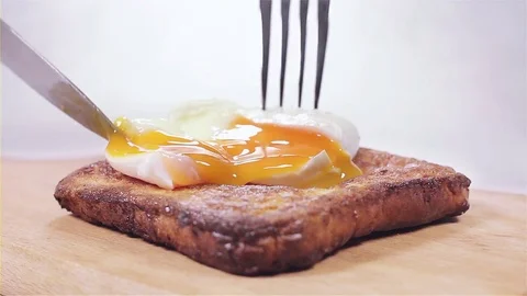 Placing a poached egg on toast Stock Footage 85012857