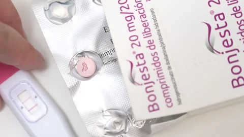Placing Positive Pregnancy Test Next to Blister Pack and Medicine Box Stock Footage 340428208