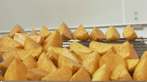 Placing the potato slices on the grill Stock Footage 142281835