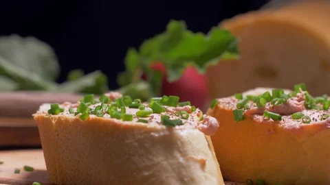 Placing radish on a slice of pate. Slow motion Stock Footage 105878837