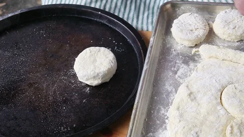 Placing raw biscuits on baking pan Stock Footage 89357926