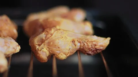 Placing Raw Chicken Wings on a Wire Rack Stock Footage 86161961