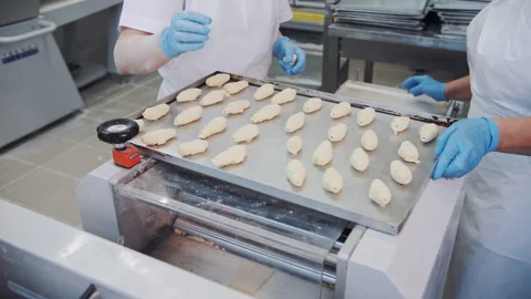 Placing Raw Croissant Dough on Baking Tray in Professional Bakery Stock Footage 321286085