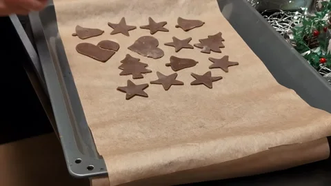 Placing raw gingerbread dough on parchment paper ready for baking Stock Footage 258431712