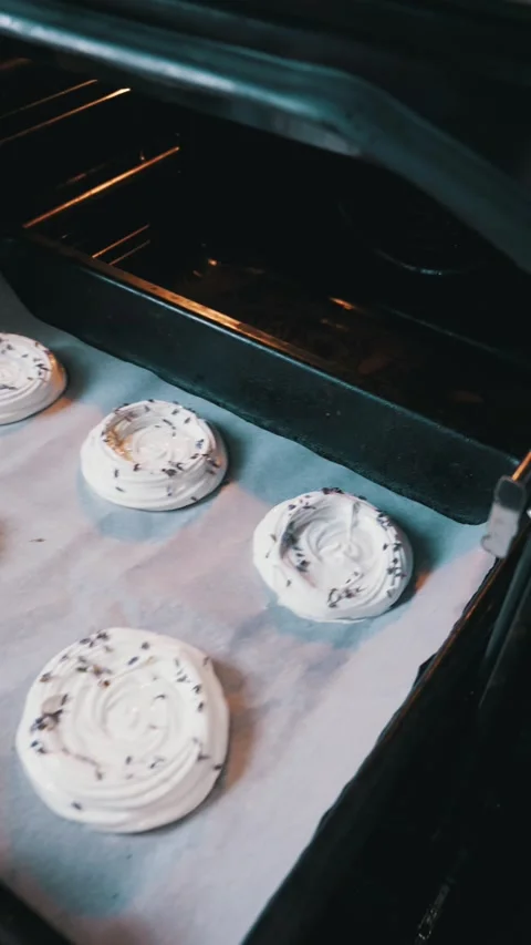 Placing Raw Lavender Meringues on Baking Tray Into Hot Oven Stock Footage 334119248
