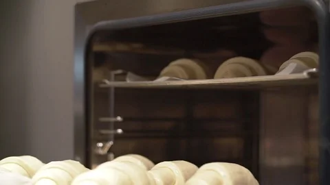 Placing ready to bake raw croissants, in the oven Stock Footage 85462625