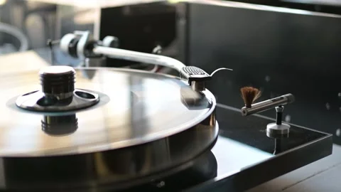 Placing the record holder on a high-end vintage turntable Stock Footage 263543190