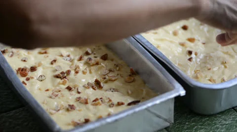 Placing roasted pecan on top of apple cake dough Stock Footage 27127025