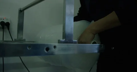 Placing Roll of Silicone Rubber into a Machine Stock Footage 73075492