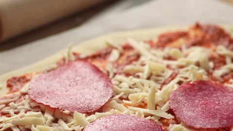 Placing Salami on Cheese Pizza. Stock Footage 263365064