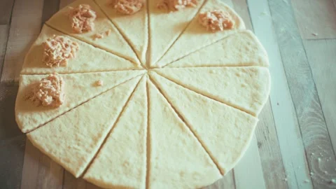 Placing savory ham and cheese filling on dough triangles close up, baking Stock Footage 337877849