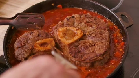 Placing Seared Osso Buco Steak into Vegetable Stew Stock Footage 312471798