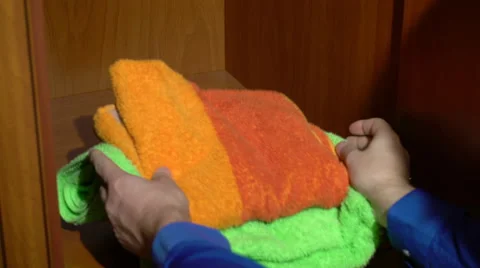 Placing a set of towels into a wardrobe Stock Footage 62083204