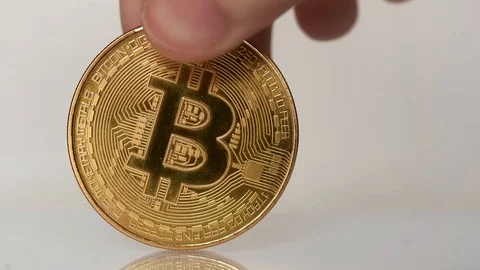 Placing a single bitcoin on the center of the frame Stock Footage 90663918