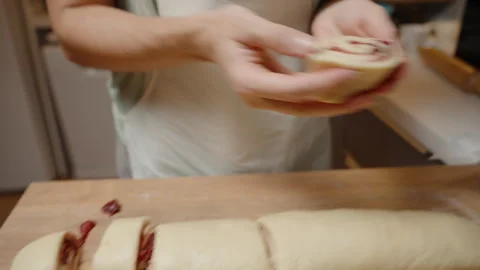 Placing a Slice of Cherry-Filled Dough Into a Parchment-Lined Baking Dish, Ready Video stock 281477495