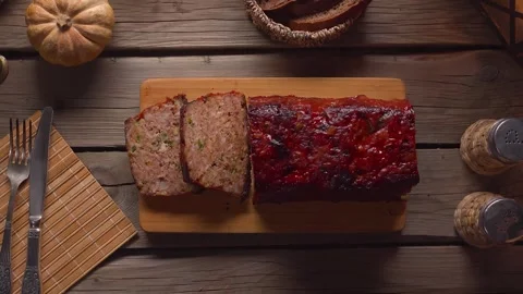 Placing Sliced Meatloaf Board on Rustic Table Top View Stock Footage 326321067