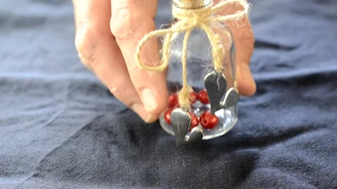 Placing a small bottle with hearts on a table 動画素材 148256509