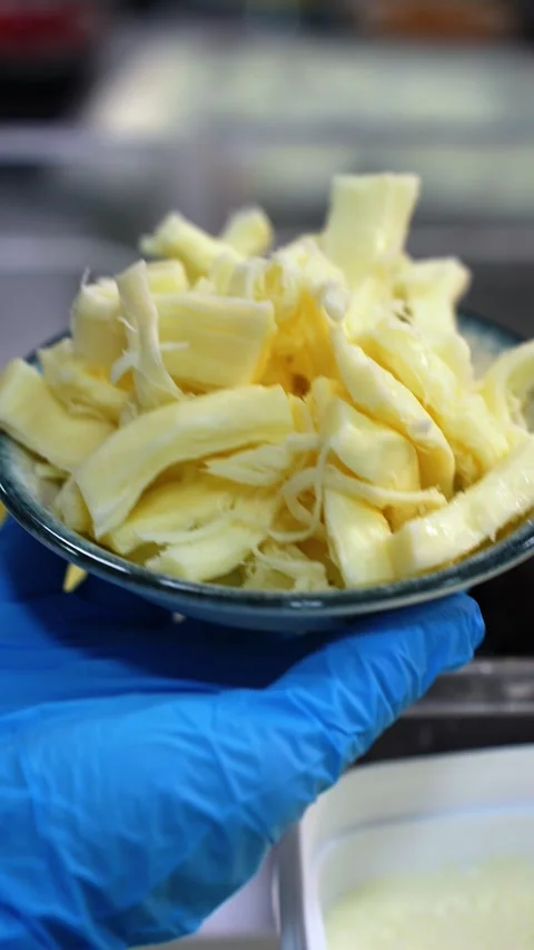 Placing String Cheese into Small Breakfast Bowl Vertical Video Stock Footage 332870243