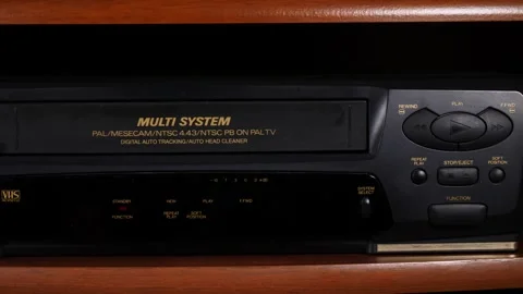 Placing a tape into VCR Vídeos de archivo 242385680