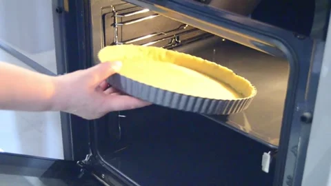 Placing tart crust into oven for baking 스톡 동영상 344661390