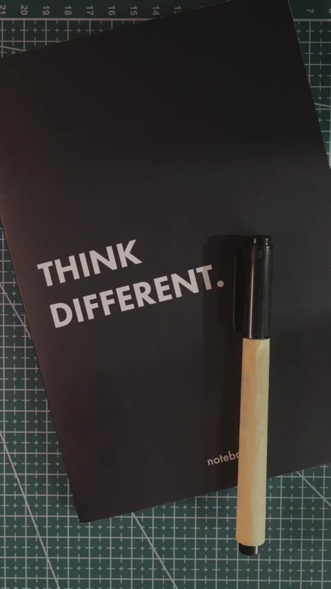 Placing Think Different notebook and marker on cutting mat Stock Footage 341246150
