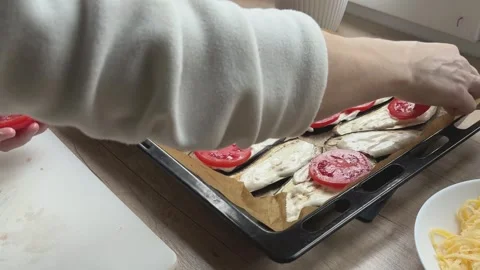 Placing Tomato Slices On Eggplant Preparing Layered Dish For Oven Cooking Vídeos de archivo 336445490