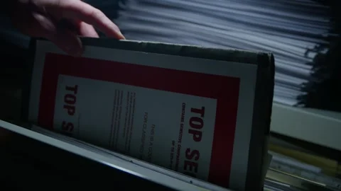 Placing a Top Secret Document into a Filing Cabinet Stock Footage 327399719