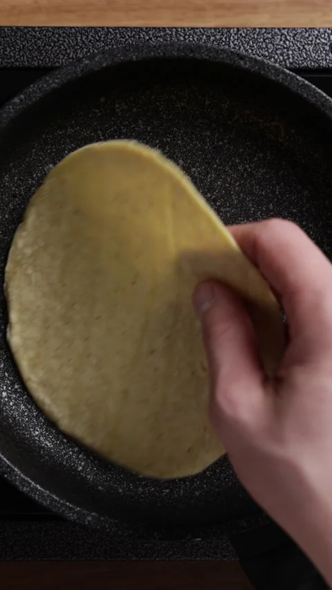 Placing Tortilla on Frying Pan Vertical Top View Vidéo 336572824