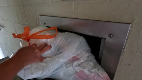 Placing trash into a  Garbage Chute at Condo nice Sound Stock Footage 247793083