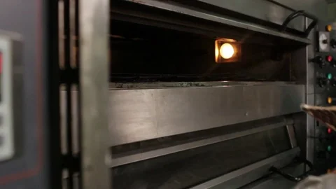 Placing tray in oven Video stock 77050984