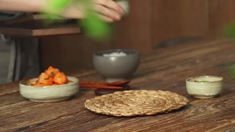 Placing Various Korean Side Dishes on Table Setting Stock Footage 335614164