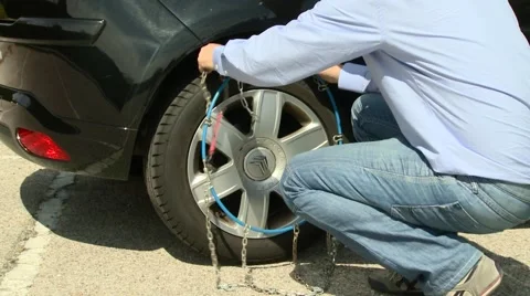 Placing wheel chains Stock Footage 54807652
