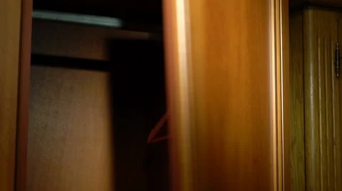 Placing white pants into a wardrobe Stock Footage 61441912