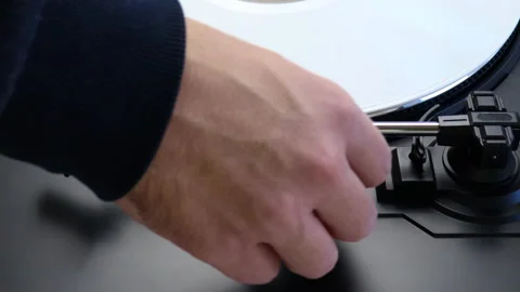 Placing white vinyl record on a turntable. Spinning white LP on a turntable Stock Footage 151162651