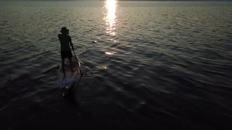 Pladdle-board into the sunset Stock Footage 138158035