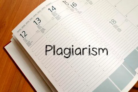 Plagiarism write on notebook Stock Photos