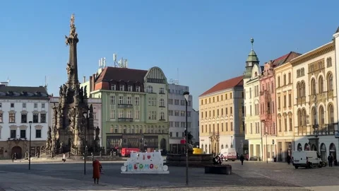 Plague column on historic square in Olomouc, tourists and people walking Stock Footage 263483604
