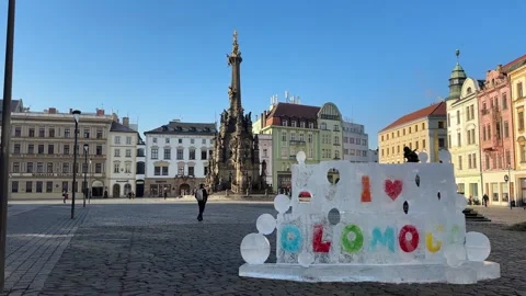 Plague column on historic town square in Olomouc, tourists and people walking Stock Footage 263483637