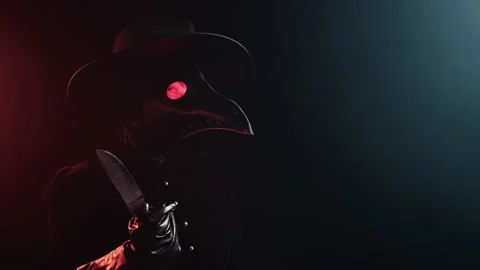 Plague doctor with sharp knife on black ... | Stock Video | Pond5
