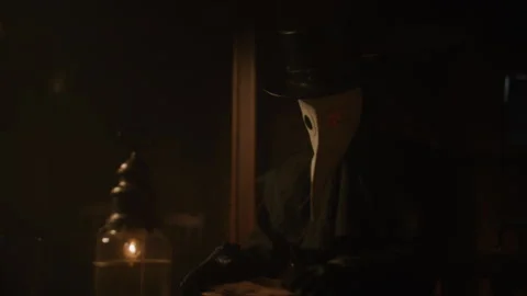 A Plague Doctor using a lantern while reading something Stock-Footage 258427518
