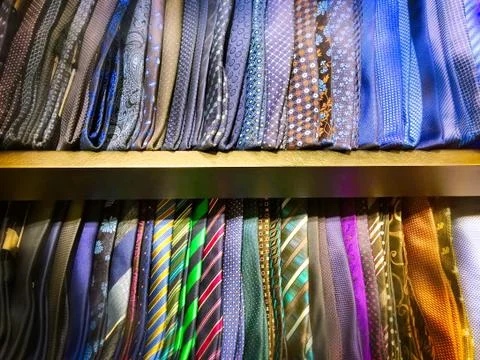 Plain and Patterned Designs of Neckties on Shelf Stock Photos