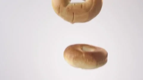 Plain bagels raining on white slow motion macro food studio 4K stock Stock Footage 337909712