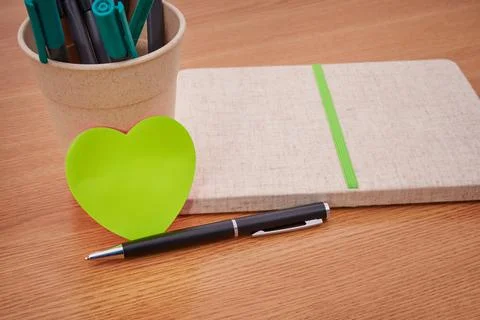 Plain Blank Open Notebooks With Stack Of Pens Inside Container Placed On Top Of Stock Photos