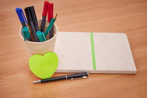 Plain Blank Open Notebooks With Stack Of Pens Inside Container Placed On Top Of 스톡 사진