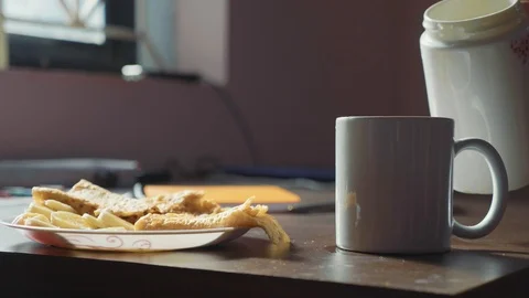 Plain breakfast with tea and pancakes. Female hand pours a tea in cup at home. Stock Footage 99900908
